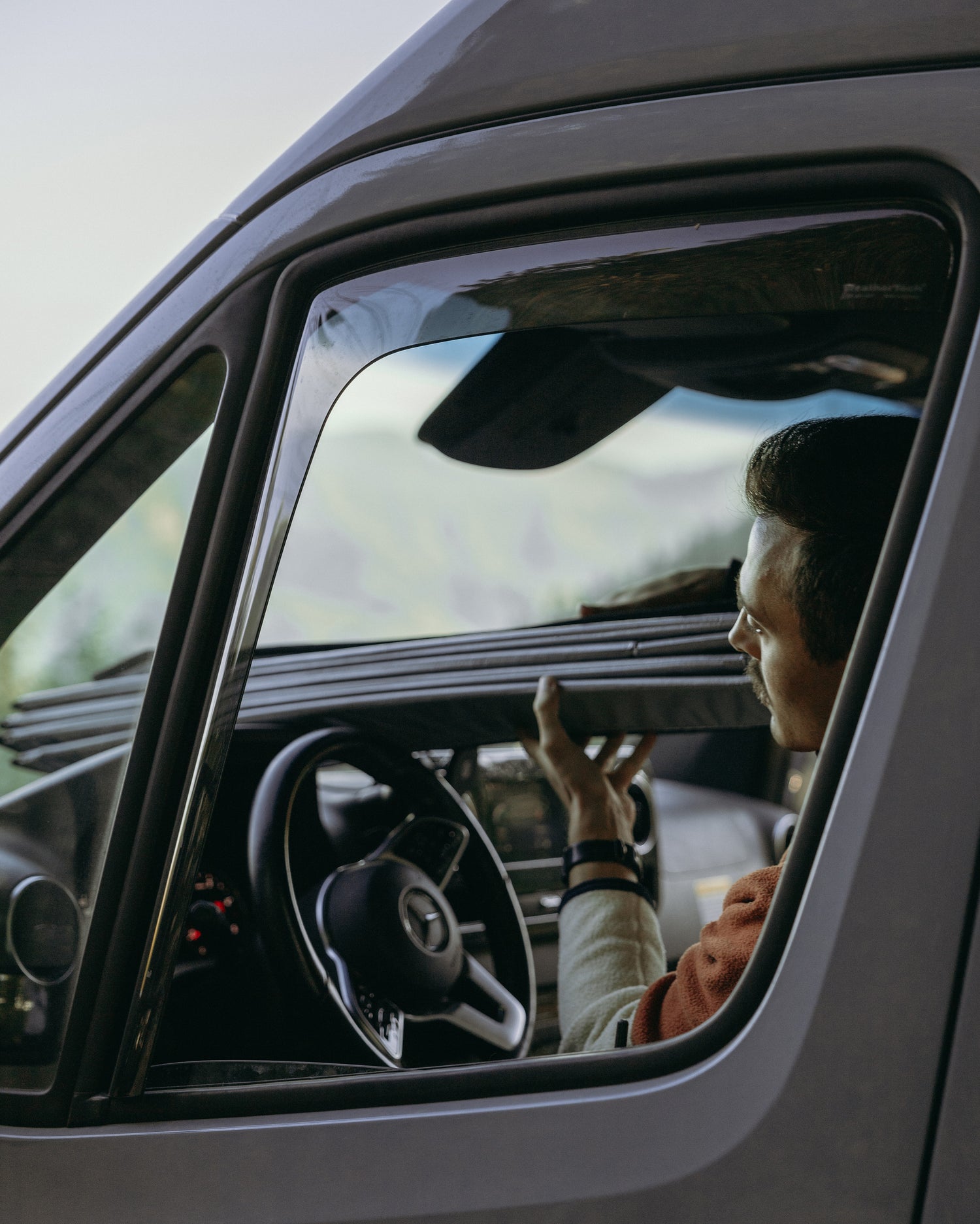 Man easily installs a VMG windshield shade